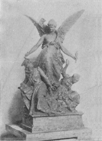 Statue of an angel with two other figures below.