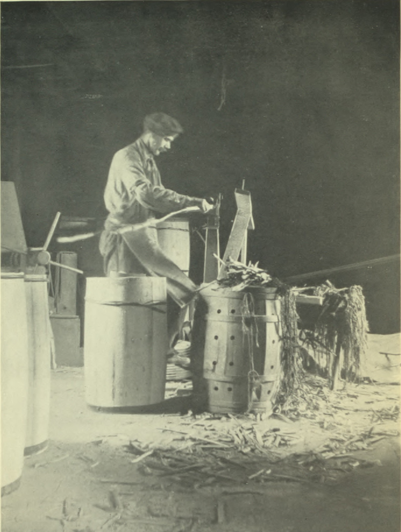 Man working making apple barrels.