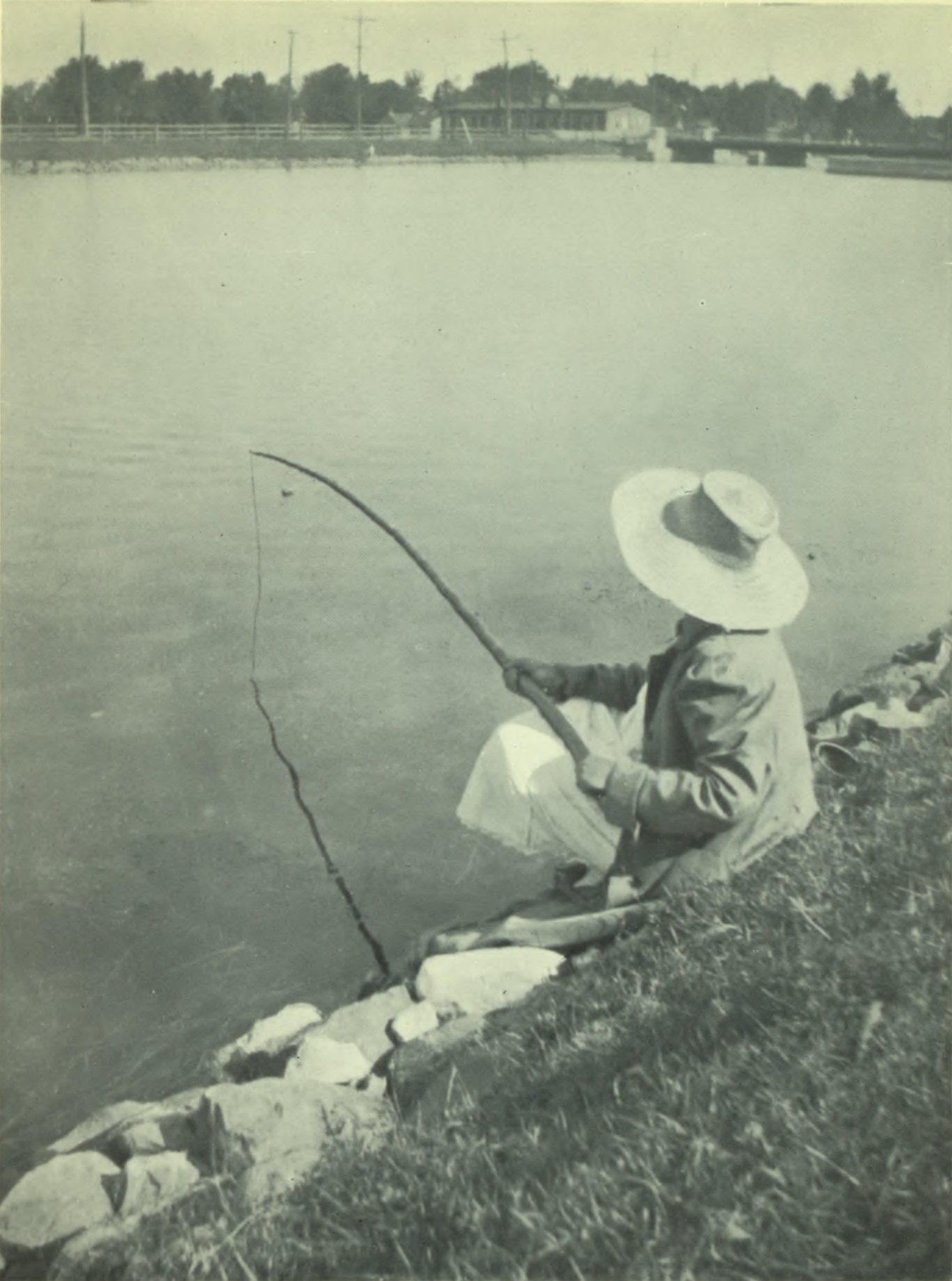 Person fishing on the bank.