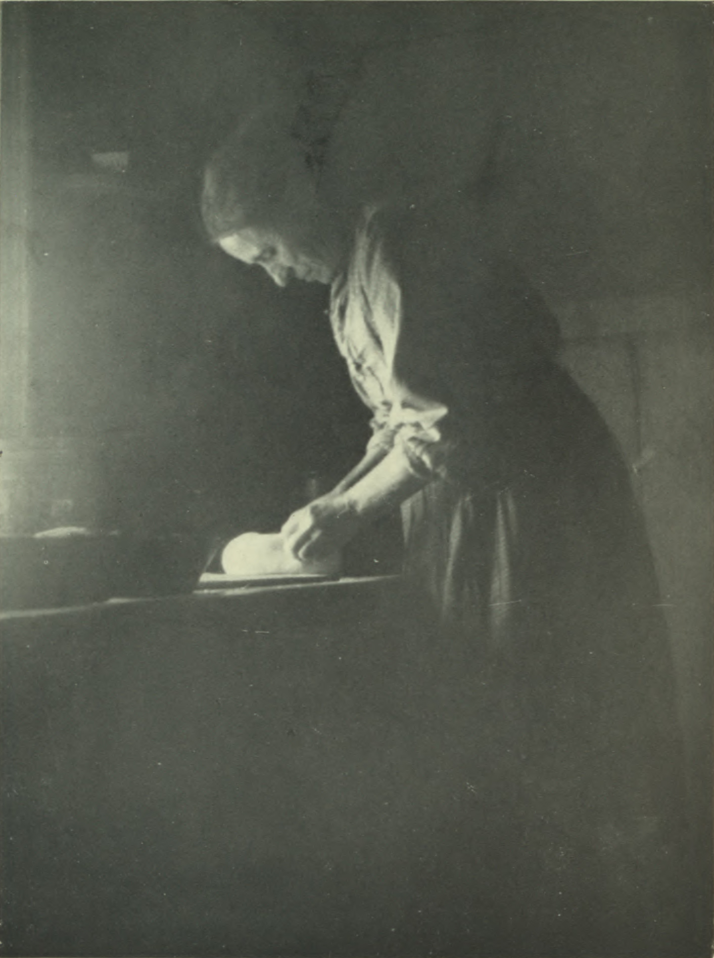 Woman kneading bread.