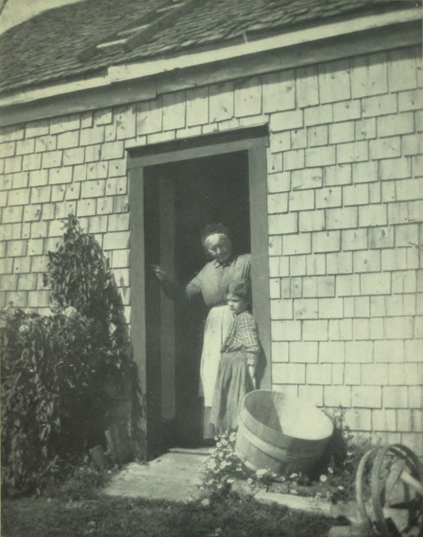 Woman and child standing in the doorway.