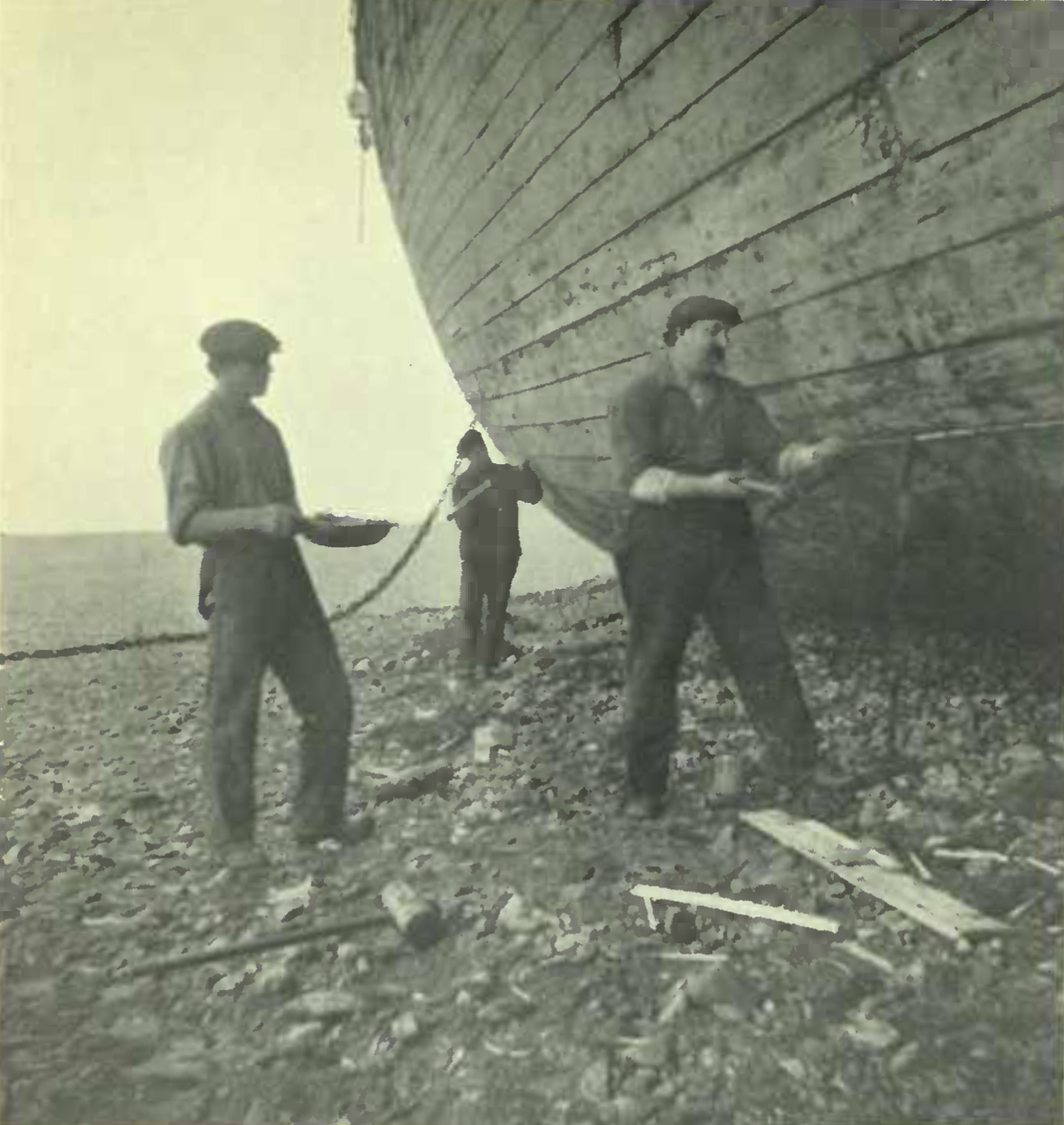 Three men tending to the side of a very tall boat.