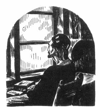 man looking out a window while sitting at a desk with open books