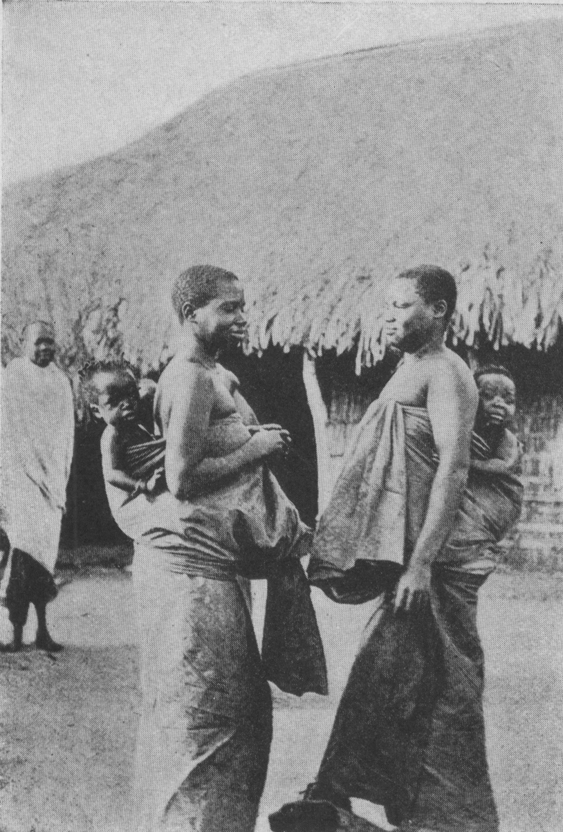 two women carrying children on their backs