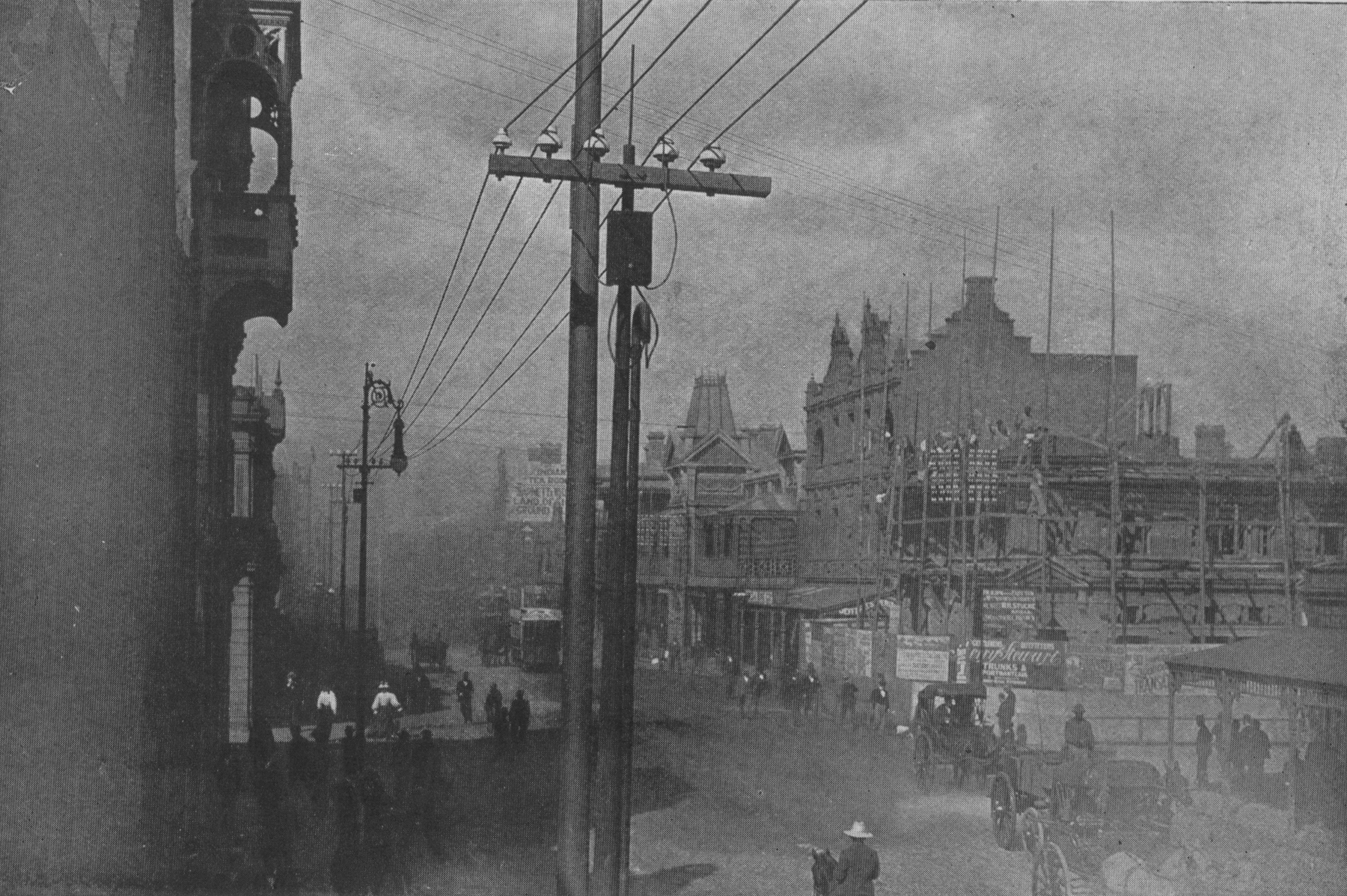 dust storm in city street with telephone poles and early cars