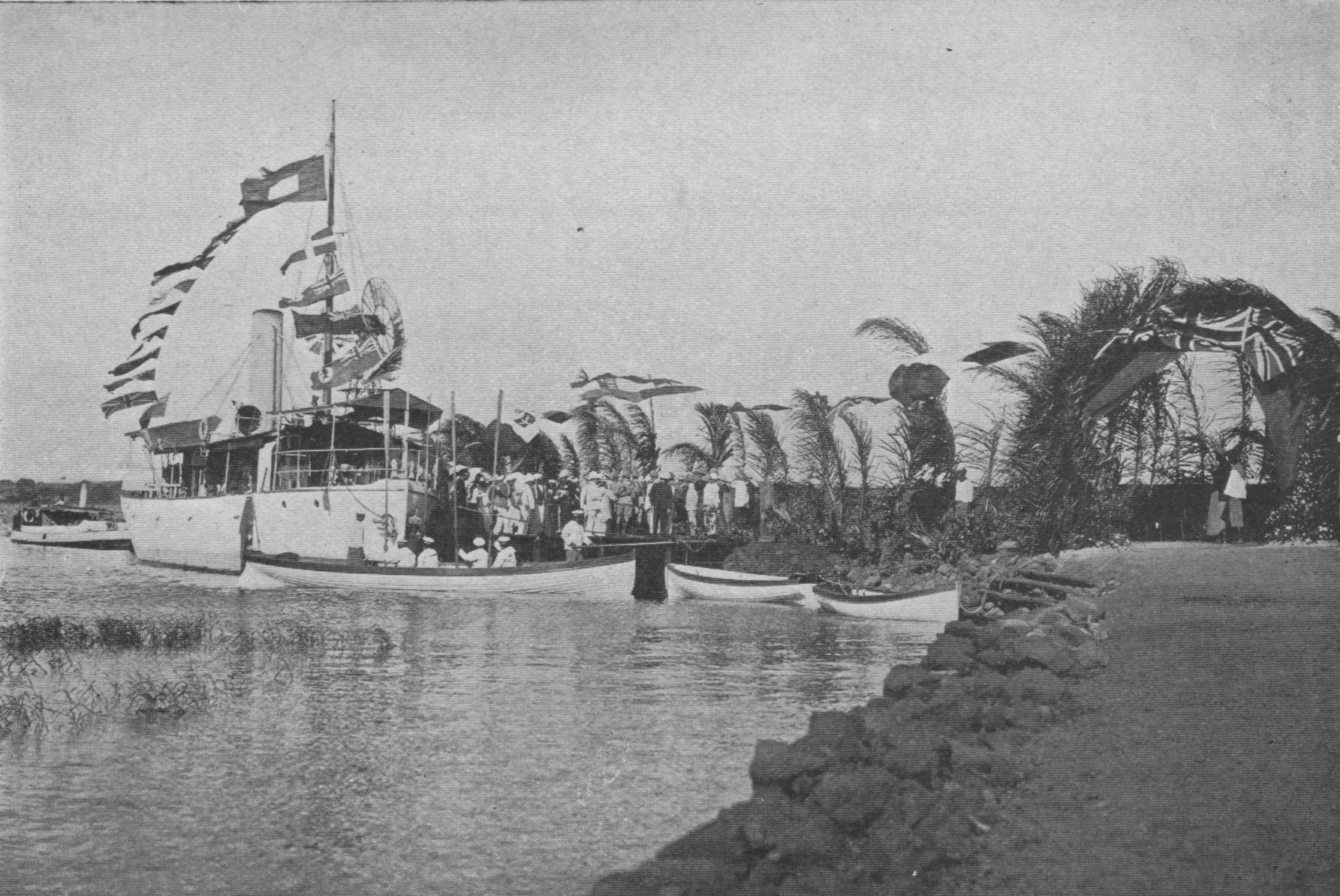 steamboat with flags at a dock