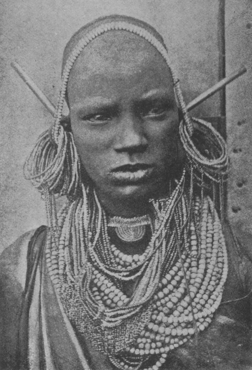 woman with beaded necklaces and head adornments
