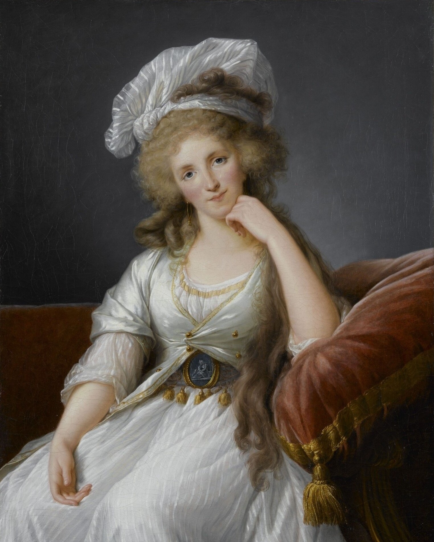 Portrait of woman seated, chin on her hand.