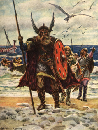 A tall man carrying a spear and shield and wearing a winged hat, walking up the beach in front of his companions.