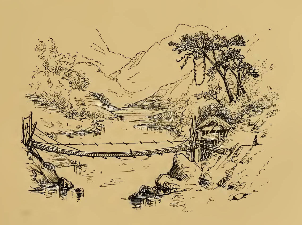 bridge crossing river with mountains in background