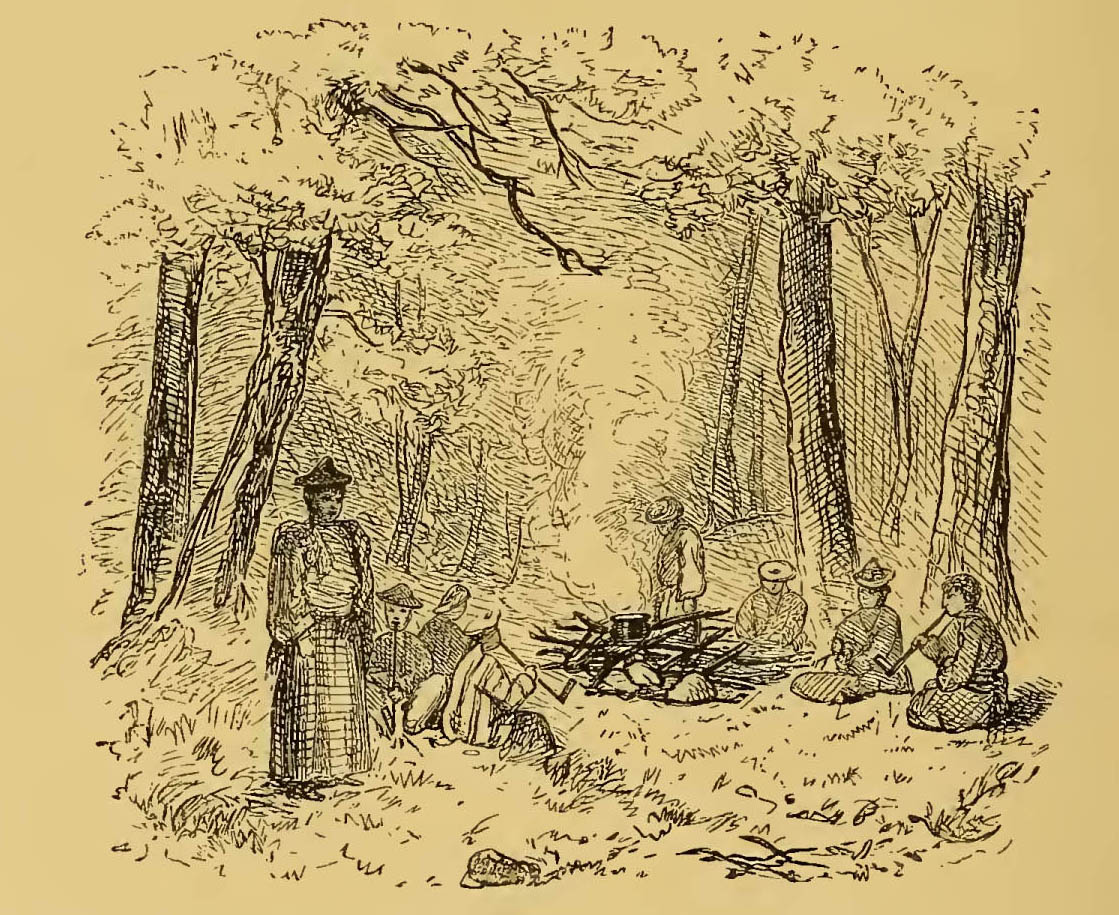 group of people sitting around a campfire in the woods