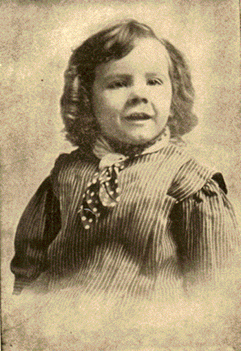 small child with long hair and scarf