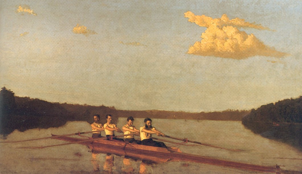 four men rowing on a river