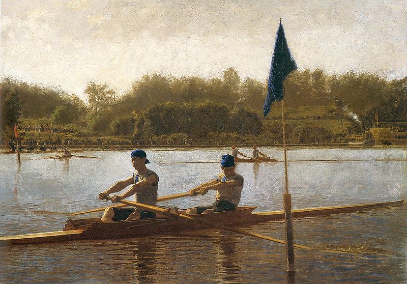 two men rowing with flag in foreground