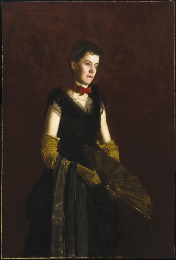 woman with fan, green gloves, and red bow around neck