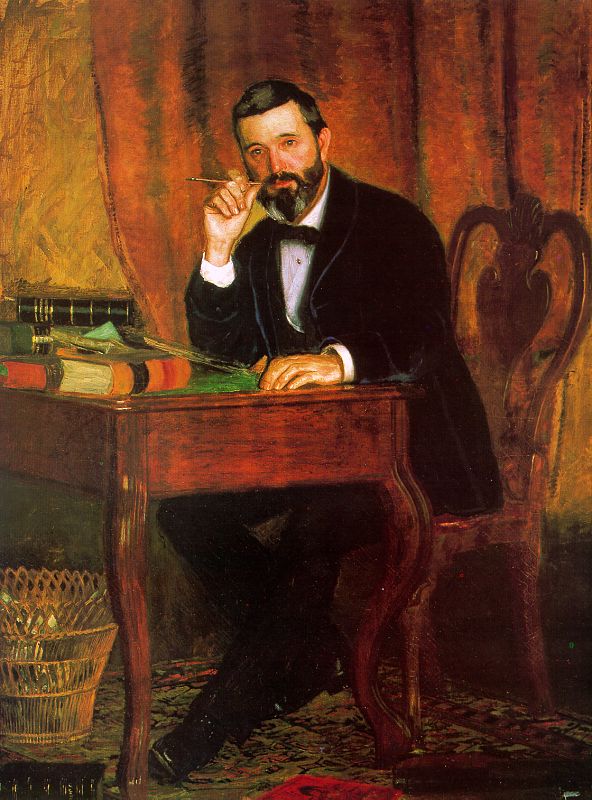 bearded man seated at desk