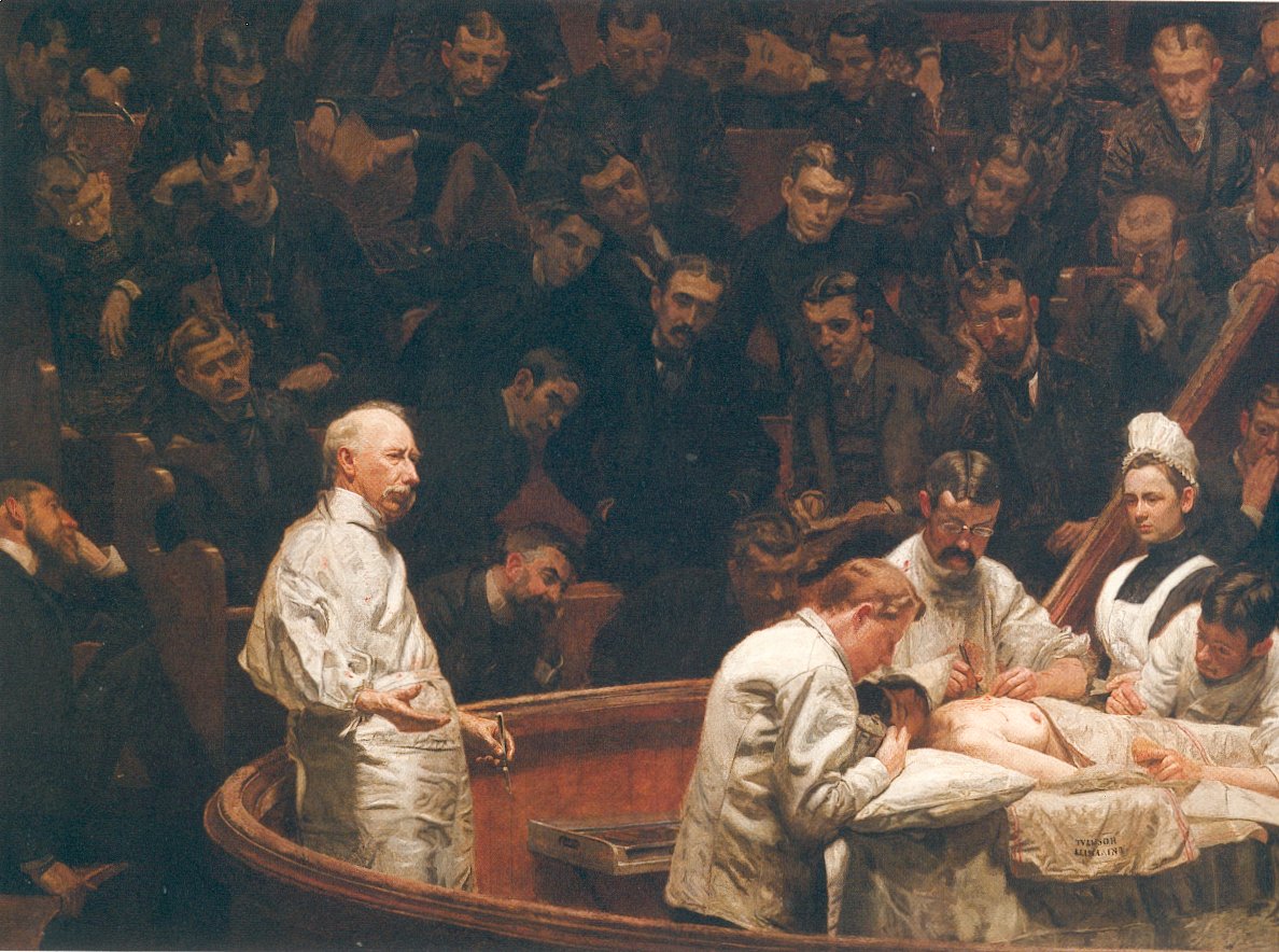 men in white clothing performing a medical operation while students observe from dark background