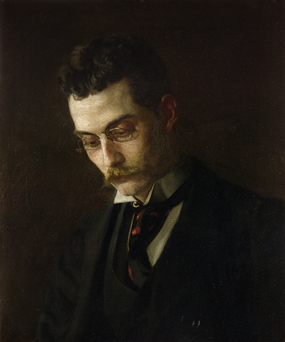 man with moustache and glasses looking downward