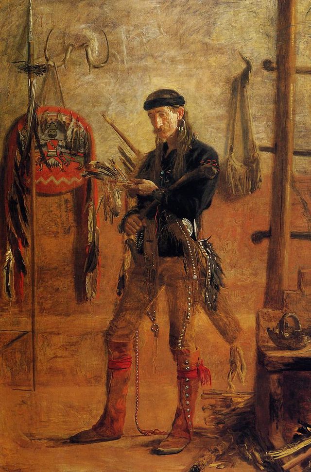 man with long hair in buckskin pants and boots