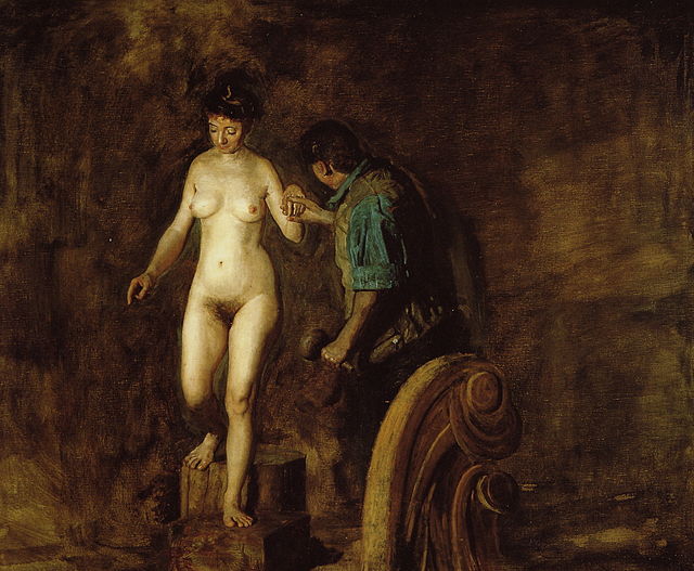 nude model holding hand of artist