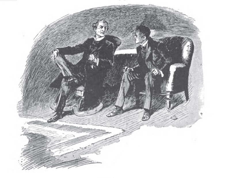Two men seated, talking