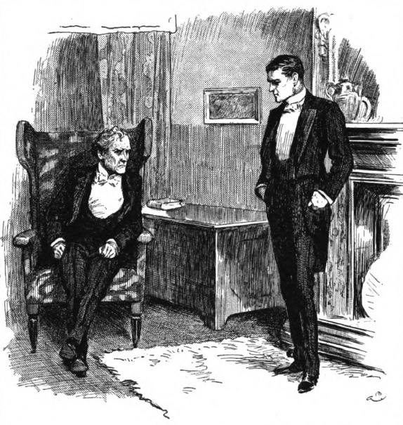 Two men talking, one seated, one standing