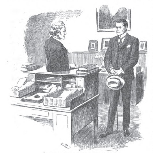 Two men stand near a desk