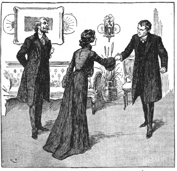 Man watches as woman and man shake hands