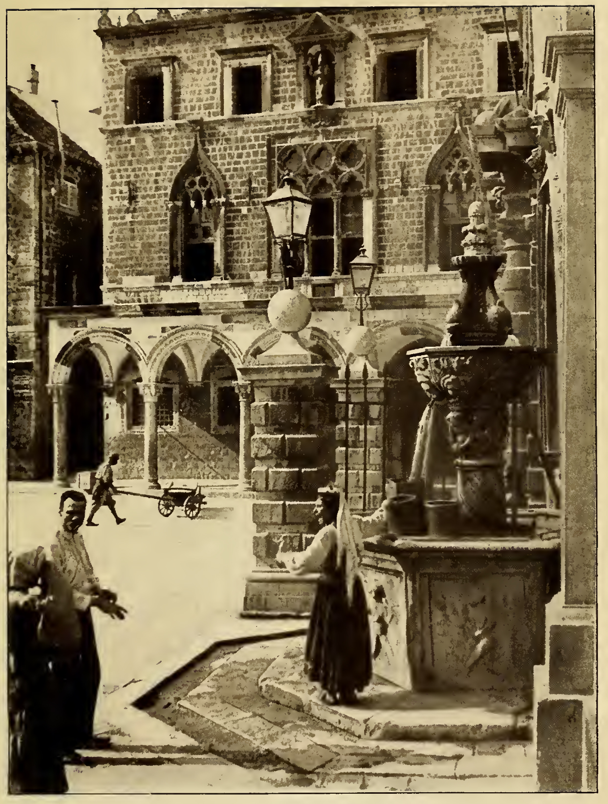 Woman filling water bucket at a tall stone fountain. Caption: Ragusa Onofrio's Famous Fountain.