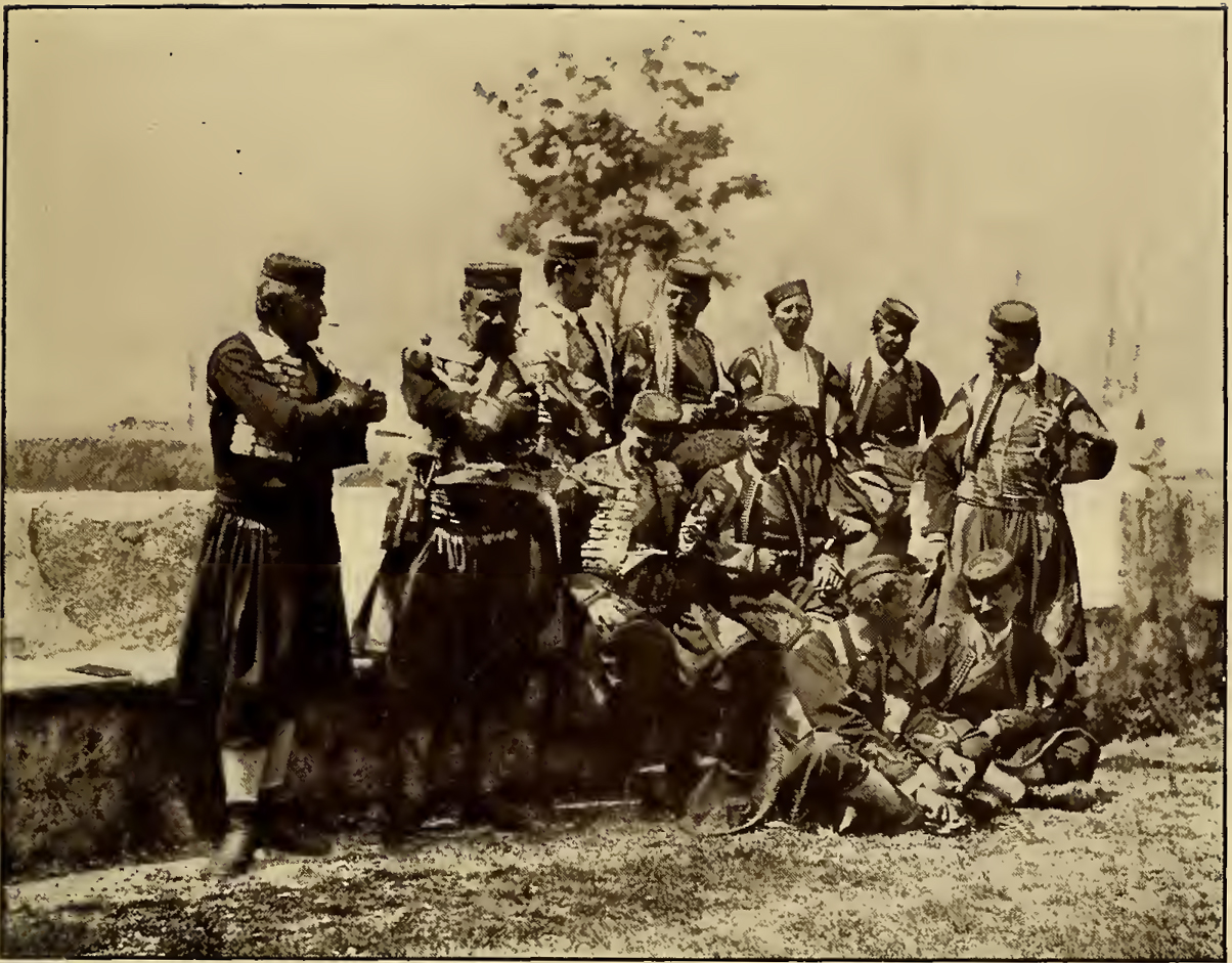 Group of men in traditional Dalmatian clothing. Caption: Cattaro Dalmatian Group.