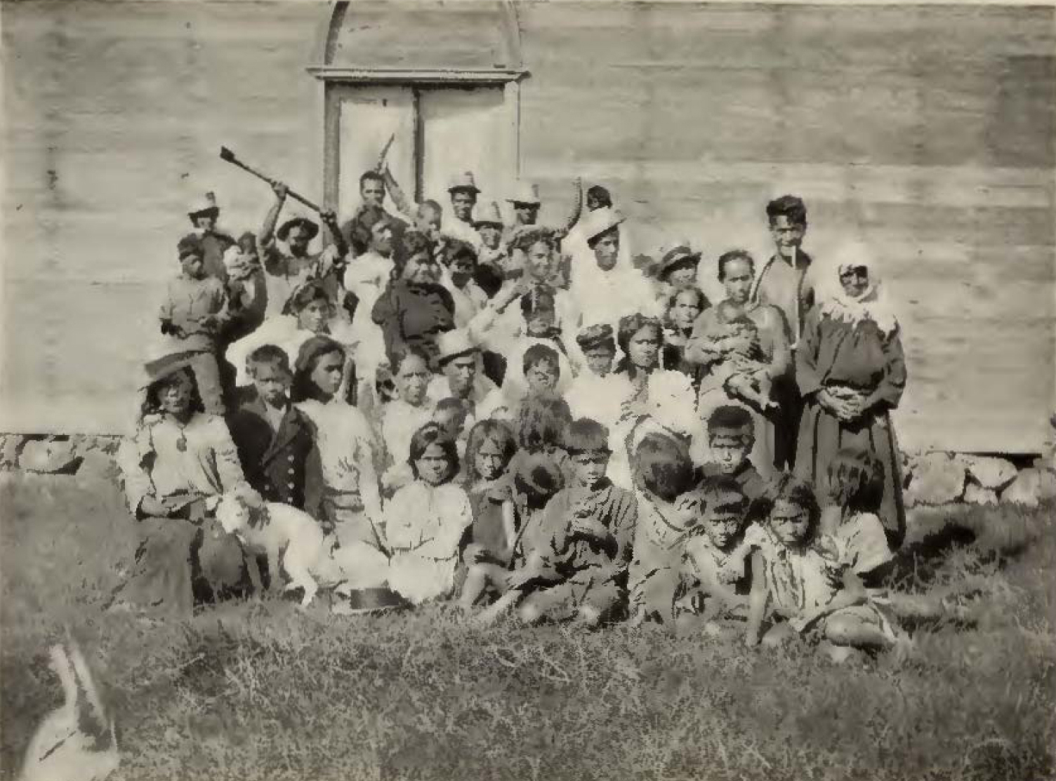 group of men, women, and children posing for picture