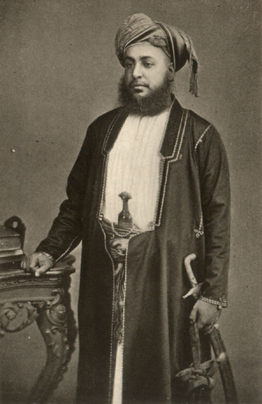 bearded man in headdress with sword
