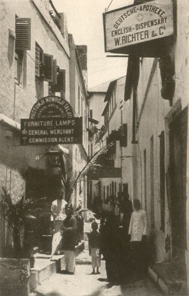 people standing in a narrow urban street