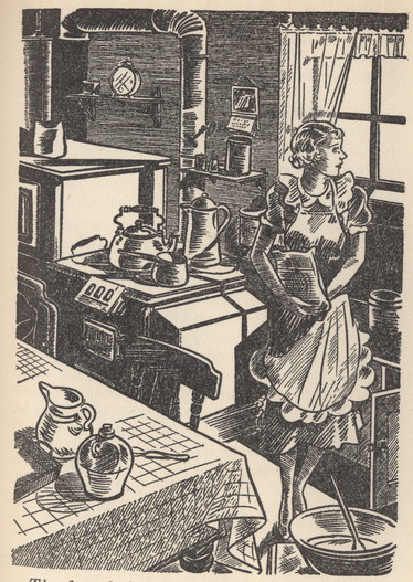Woman in kitchen wearing an apron and a dress.