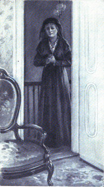 Woman in black standing in the hall.