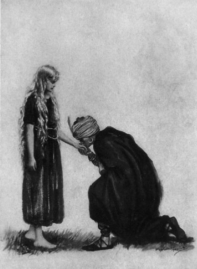 Man with turban kneeling and kissing the hand of a young woman.