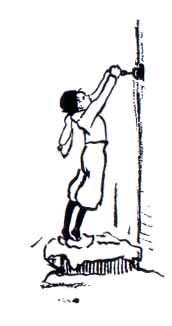 Boy standing reaching up ringing a doorbell.