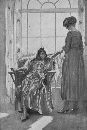 woman seated facing away from a large window brushing her hair while standing woman looks down at her