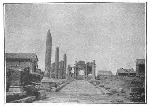 ancient ruins of a street, columns, and buildings
